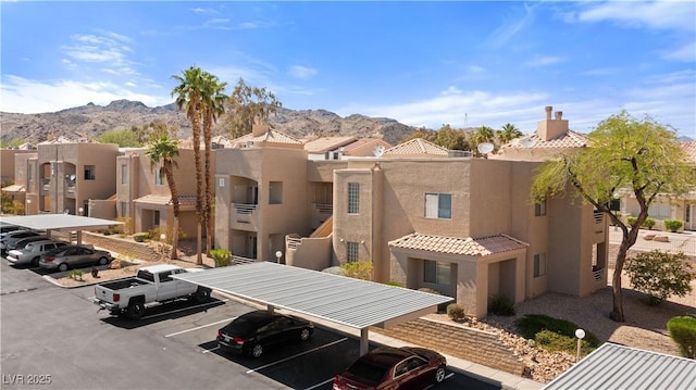 2200 Highpointe Dr Unit 202, Laughlin, NV 89029 - view of building exterior with covered and uncovered parking, a mountain view, and a residential view