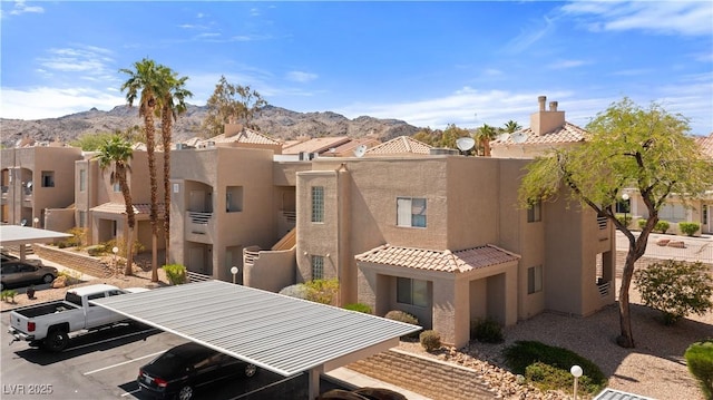 2200 Highpointe Dr Unit 202, Laughlin, NV 89029 - rear view of house with a mountain view, stucco siding, uncovered parking, and a residential view