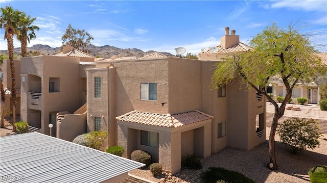 2200 Highpointe Dr Unit 202, Laughlin, NV 89029 - view of front of home featuring stucco siding, a mountain view, and a tile roof