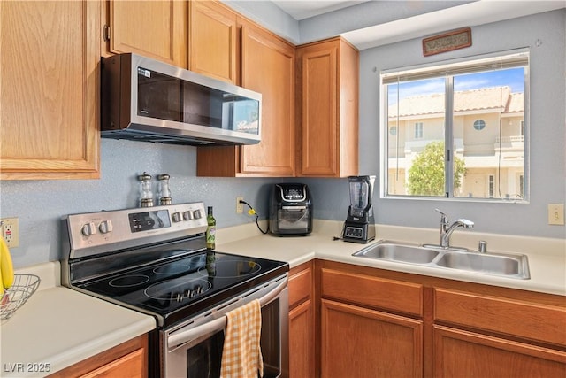 2200 Highpointe Dr Unit 202, Laughlin, NV 89029 - kitchen with stainless steel appliances, a sink, light countertops, and brown cabinets