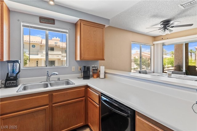 2200 Highpointe Dr Unit 202, Laughlin, NV 89029 - kitchen with a sink, dishwasher, light countertops, ceiling fan, and a textured ceiling
