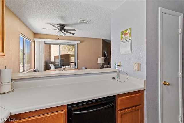 2200 Highpointe Dr Unit 202, Laughlin, NV 89029 - kitchen with a textured wall, ceiling fan, dishwasher, a textured ceiling, and light countertops