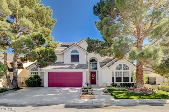7109 Deepriver Cir, Las Vegas, NV 89129 - traditional home with stucco siding, concrete driveway, a garage, and roof mounted solar panels