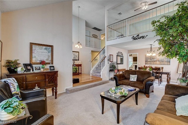 7109 Deepriver Cir, Las Vegas, NV 89129 - living room with a towering ceiling, a chandelier, carpet floors, stairway, and baseboards