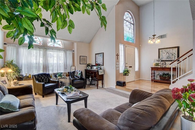 7109 Deepriver Cir, Las Vegas, NV 89129 - carpeted living area featuring high vaulted ceiling, healthy amount of natural light, a chandelier, and stairs