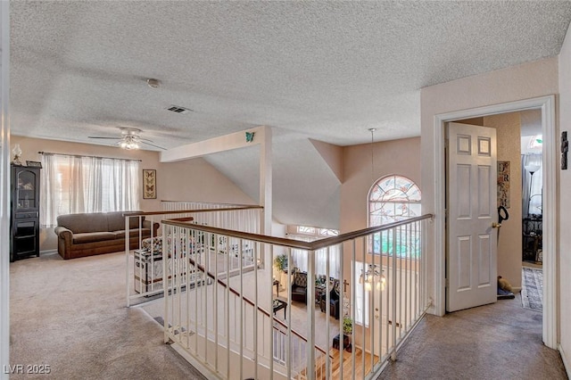 7109 Deepriver Cir, Las Vegas, NV 89129 - corridor featuring healthy amount of natural light, carpet floors, an upstairs landing, and a textured ceiling