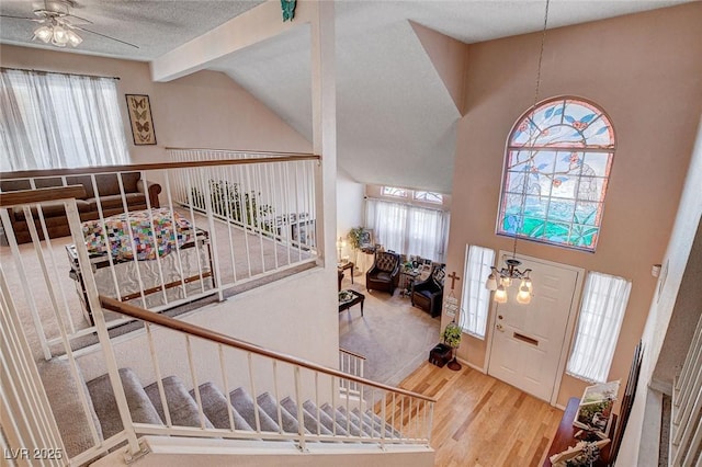 7109 Deepriver Cir, Las Vegas, NV 89129 - foyer featuring wood finished floors, a ceiling fan, vaulted ceiling, and stairway