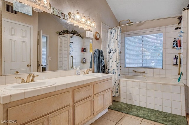 7109 Deepriver Cir, Las Vegas, NV 89129 - bathroom featuring tile patterned flooring, tiled shower / bath, vaulted ceiling, and double vanity