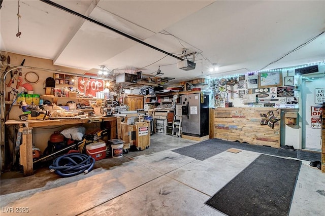 7109 Deepriver Cir, Las Vegas, NV 89129 - garage featuring a workshop area, stainless steel fridge with ice dispenser, and a garage door opener