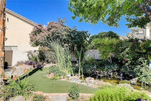 7109 Deepriver Cir, Las Vegas, NV 89129 - fenced backyard with a garden pond