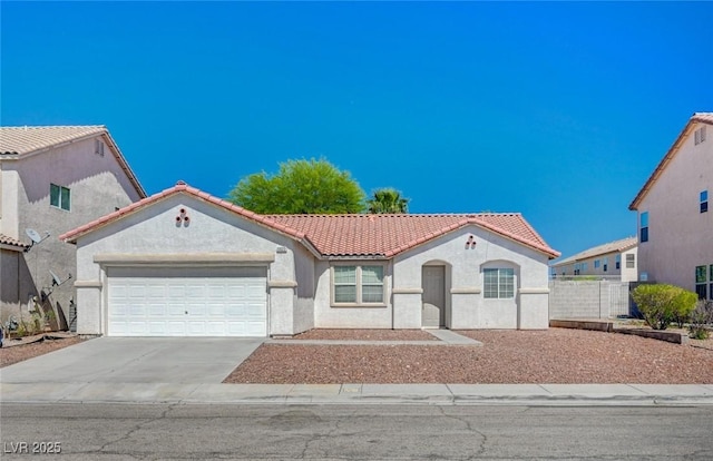 5622 Sage Pines Dr, Las Vegas, NV 89118 - mediterranean / spanish home featuring a tile roof, stucco siding, a garage, and driveway
