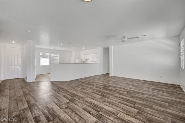 5622 Sage Pines Dr, Las Vegas, NV 89118 - unfurnished living room featuring dark wood-style floors and a ceiling fan