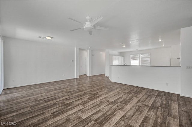 5622 Sage Pines Dr, Las Vegas, NV 89118 - unfurnished living room with ceiling fan, dark wood-style floors, and baseboards