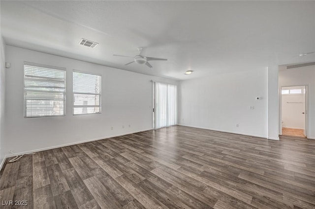 5622 Sage Pines Dr, Las Vegas, NV 89118 - empty room with a ceiling fan, healthy amount of natural light, dark wood-style floors, and baseboards