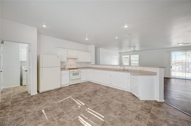 5622 Sage Pines Dr, Las Vegas, NV 89118 - kitchen featuring white appliances, a sink, healthy amount of natural light, light countertops, and recessed lighting
