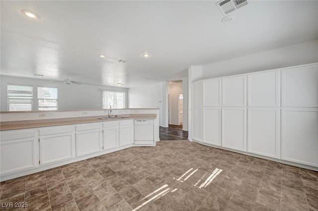 5622 Sage Pines Dr, Las Vegas, NV 89118 - kitchen featuring a sink, white cabinetry, light countertops, tile patterned floors, and recessed lighting