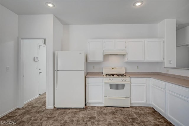 5622 Sage Pines Dr, Las Vegas, NV 89118 - kitchen with white appliances, white cabinets, under cabinet range hood, recessed lighting, and light countertops