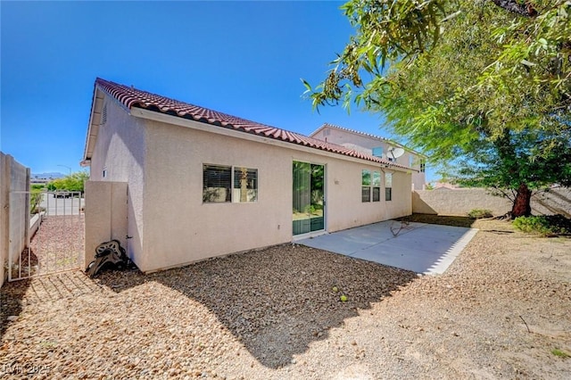 5622 Sage Pines Dr, Las Vegas, NV 89118 - rear view of property featuring a fenced backyard, stucco siding, a tiled roof, and a patio area