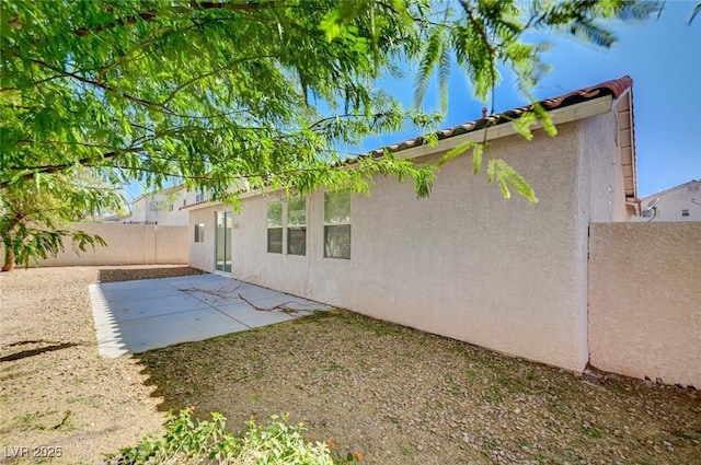 5622 Sage Pines Dr, Las Vegas, NV 89118 - rear view of house with stucco siding and a patio area