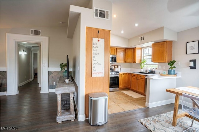 520 Arrowhead Trl Unit 1322, Henderson, NV 89015 - kitchen with appliances with stainless steel finishes, light countertops, a sink, wood finished floors, and baseboards