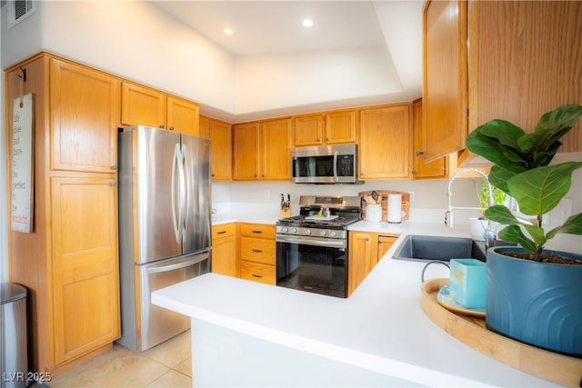 520 Arrowhead Trl Unit 1322, Henderson, NV 89015 - kitchen with appliances with stainless steel finishes, a sink, light countertops, light tile patterned flooring, and a peninsula