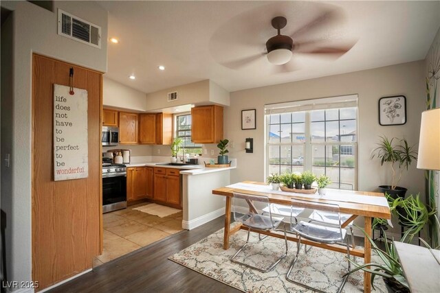 520 Arrowhead Trl Unit 1322, Henderson, NV 89015 - kitchen featuring appliances with stainless steel finishes, light countertops, plenty of natural light, wood finished floors, and recessed lighting