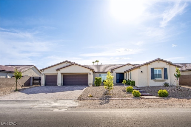 8665 Jerlyn St, Las Vegas, NV 89113 - ranch-style home featuring driveway, a garage, stucco siding, and a tile roof