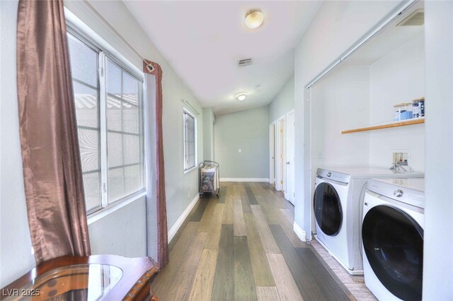 6233 Overhang Ave, Henderson, NV 89011 - laundry area featuring independent washer and dryer, wood finished floors, plenty of natural light, and baseboards