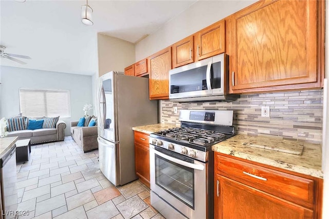 6233 Overhang Ave, Henderson, NV 89011 - kitchen with appliances with stainless steel finishes, open floor plan, backsplash, and a ceiling fan