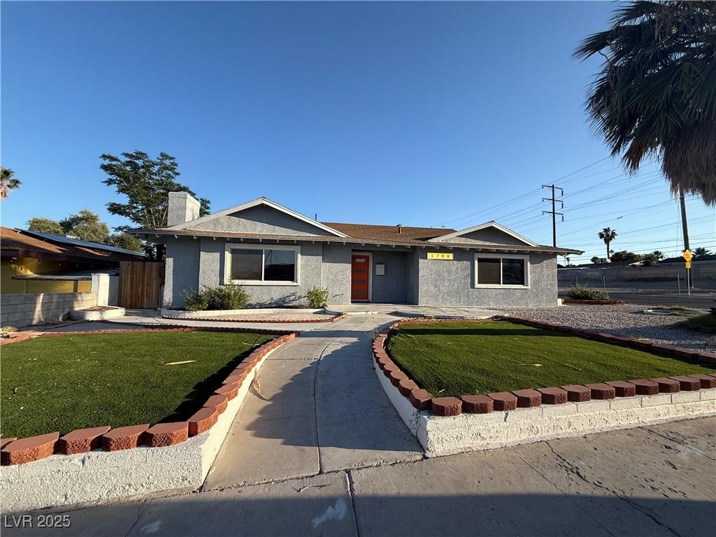 1700 E Oakey Blvd, Las Vegas, NV 89104 - ranch-style home featuring a front lawn, stucco siding, and a chimney