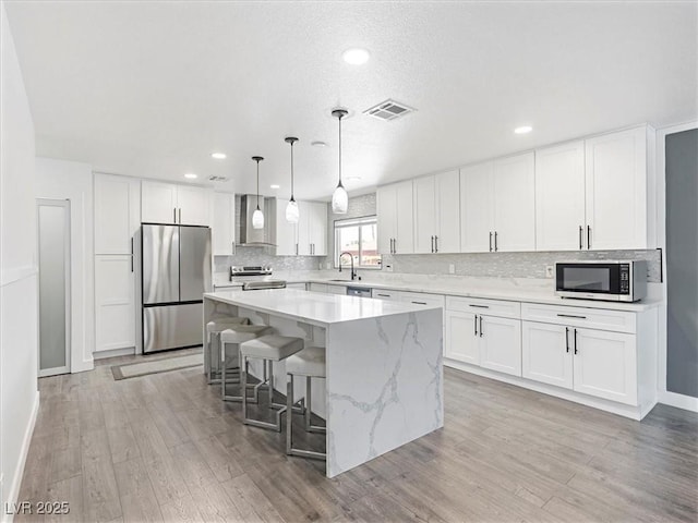 1700 E Oakey Blvd, Las Vegas, NV 89104 - kitchen with stainless steel appliances, a sink, a center island, baseboards, and tasteful backsplash