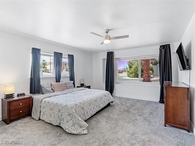 1700 E Oakey Blvd, Las Vegas, NV 89104 - bedroom featuring multiple windows, carpet, baseboards, a textured ceiling, and ceiling fan