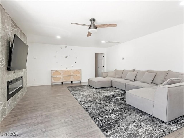 1700 E Oakey Blvd, Las Vegas, NV 89104 - living area featuring a fireplace, wood finished floors, a ceiling fan, and recessed lighting
