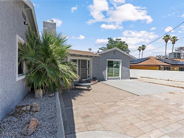1700 E Oakey Blvd, Las Vegas, NV 89104 - back of property featuring stucco siding, a patio area, and a chimney