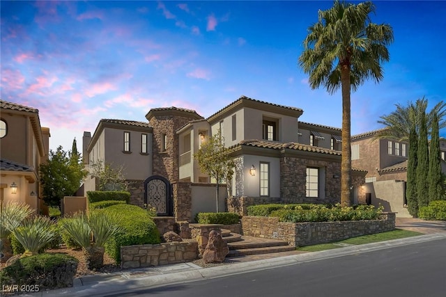 11503 Glowing Sunset Ln, Las Vegas, NV 89135 - mediterranean / spanish house with stucco siding, stone siding, and a tile roof