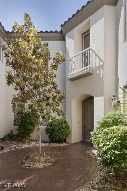 11503 Glowing Sunset Ln, Las Vegas, NV 89135 - doorway to property featuring a balcony and stucco siding