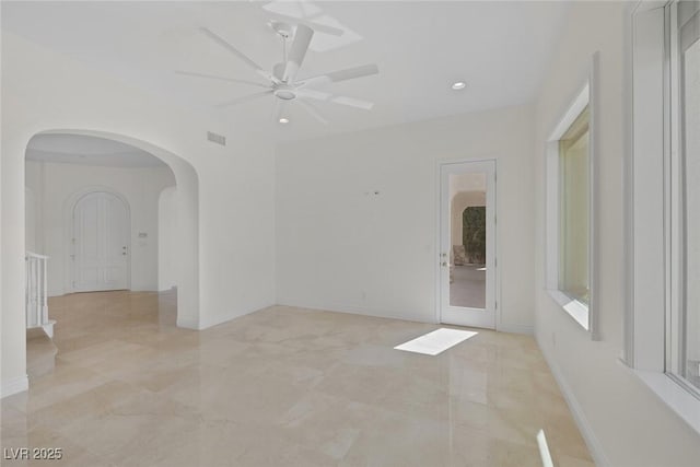 11503 Glowing Sunset Ln, Las Vegas, NV 89135 - spare room with arched walkways, ceiling fan, recessed lighting, and baseboards
