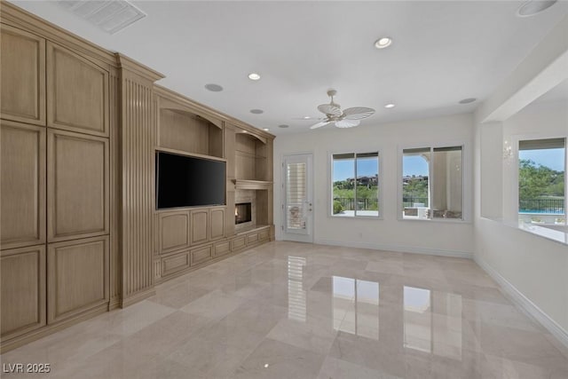 11503 Glowing Sunset Ln, Las Vegas, NV 89135 - unfurnished living room featuring ceiling fan, a premium fireplace, recessed lighting, baseboards, and built in shelves