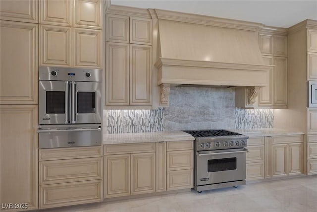 11503 Glowing Sunset Ln, Las Vegas, NV 89135 - kitchen featuring cream cabinetry, appliances with stainless steel finishes, and a warming drawer