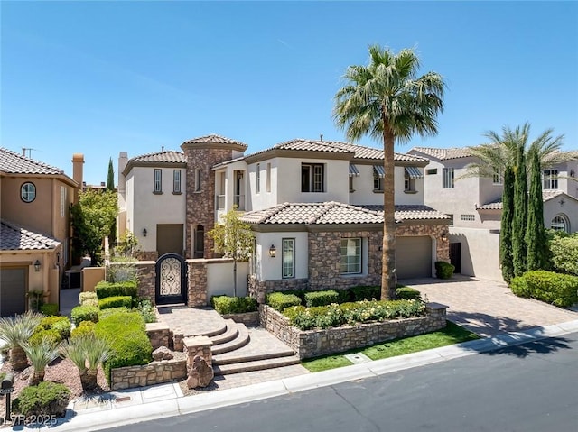 11503 Glowing Sunset Ln, Las Vegas, NV 89135 - mediterranean / spanish home with stucco siding, stone siding, a gate, driveway, and an attached garage