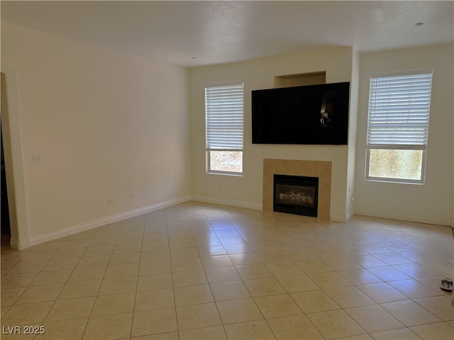5855 Valley Dr Unit 1070, North Las Vegas, NV 89031 - unfurnished living room with plenty of natural light, a fireplace, and light tile patterned flooring