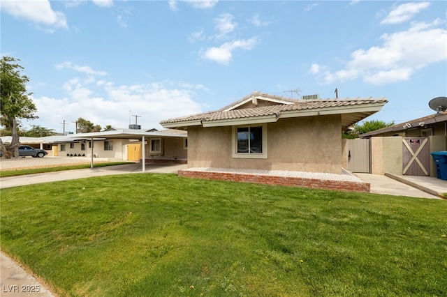 22 Jade Cir, Las Vegas, NV 89106 - rear view of property featuring stucco siding, a yard, and a tile roof