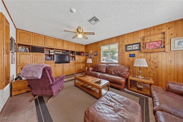 22 Jade Cir, Las Vegas, NV 89106 - carpeted living area featuring a textured ceiling, ceiling fan, and wood walls