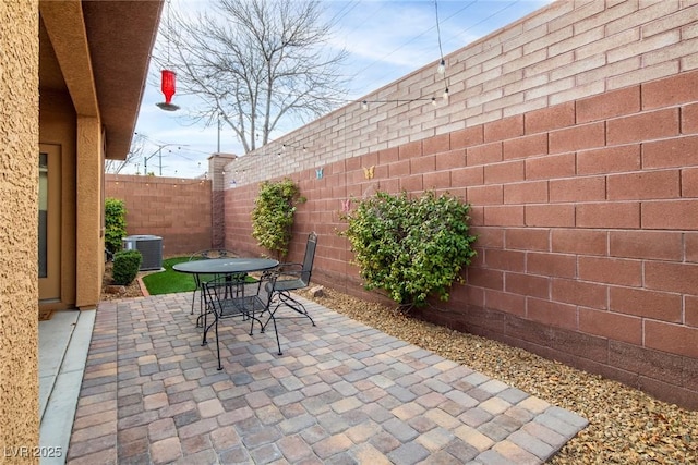7611 Redcloud Peak St, Las Vegas, NV 89166 - fenced backyard with central AC unit, a patio area, and outdoor dining area