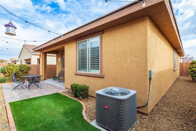 7611 Redcloud Peak St, Las Vegas, NV 89166 - view of side of home with central AC, stucco siding, and a patio area