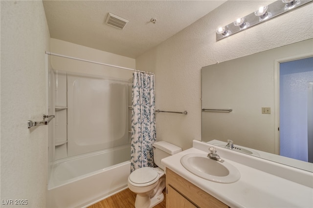 2040 Mesquite Ln Unit 203, Laughlin, NV 89029 - bathroom with wood finished floors, toilet, vanity, shower / bathtub combination with curtain, and a textured wall