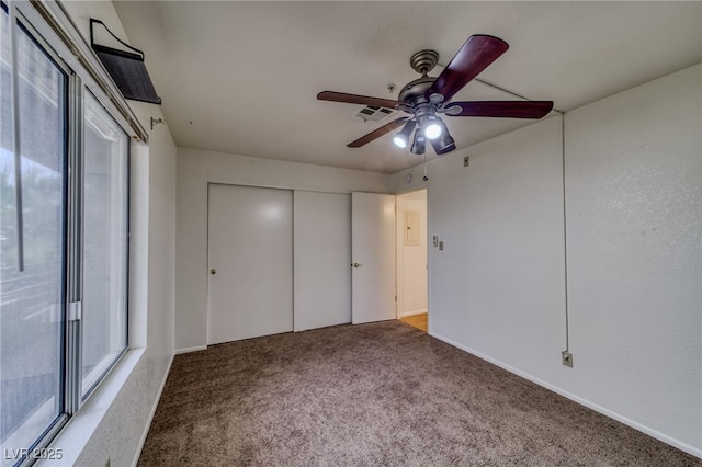 2040 Mesquite Ln Unit 203, Laughlin, NV 89029 - unfurnished bedroom with multiple windows, carpet floors, a closet, and ceiling fan