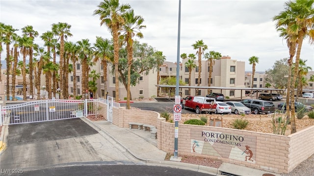2040 Mesquite Ln Unit 203, Laughlin, NV 89029 - partially covered parking lot featuring a residential view and a gate