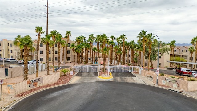 2040 Mesquite Ln Unit 203, Laughlin, NV 89029 - view of asphalt road with curbs, a gate, street lights, a residential view, and a gated entry
