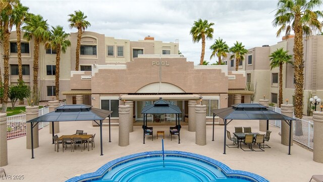 2040 Mesquite Ln Unit 203, Laughlin, NV 89029 - view of swimming pool featuring a gazebo, a hot tub, and outdoor dining area